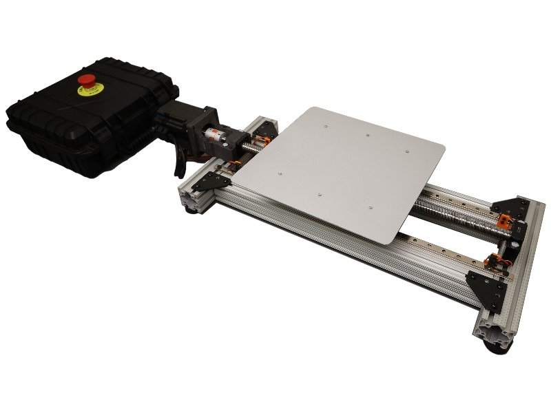 ShakeBot-100 shake table showing the 50 x 50 cm top plate, ball-screw servo drive and linear guides